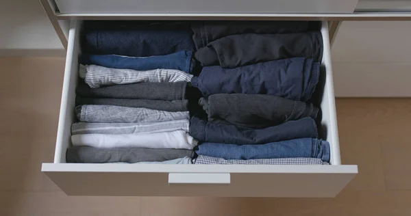 Open the drawer with clothes at home