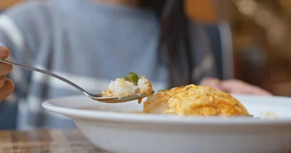 Woman enjoy the omelette curry rice