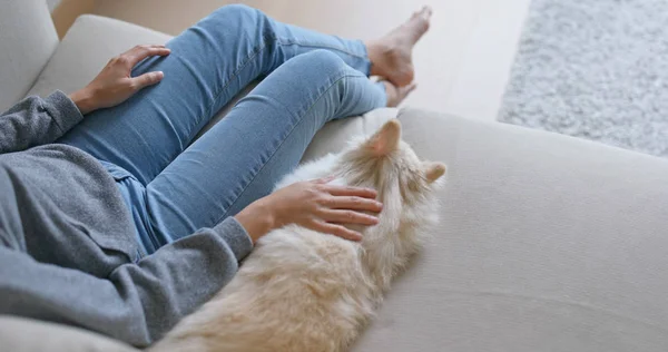 Woman cuddle her dog at home