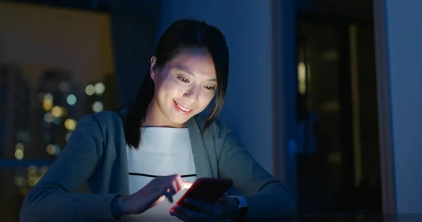 Woman check on mobile phone in the evening at night