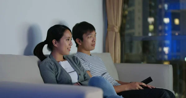 Couple watch tv at home