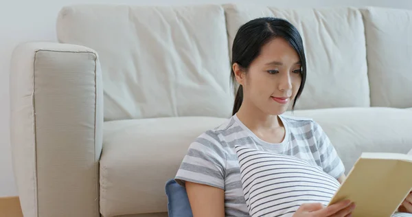 Woman read book and sit on sofa at home