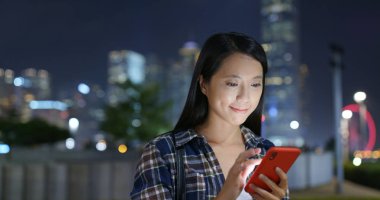 Kadın gece şehirde online cep telefonu kullanmak