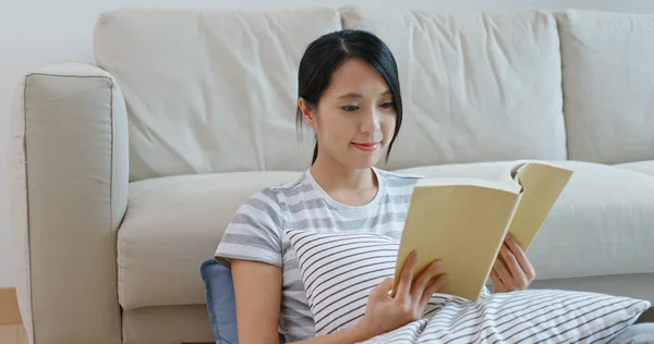 Woman read book and sit on sofa at home