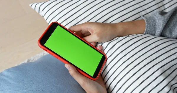 Woman use of mobile phone with green screen