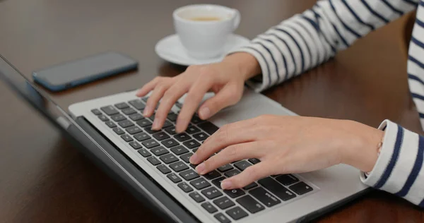 Woman type on computer at home