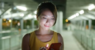 Kadın geceleri smartphone şehir içinde bak