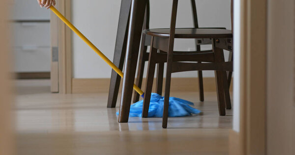 Housewife clean floor with mop