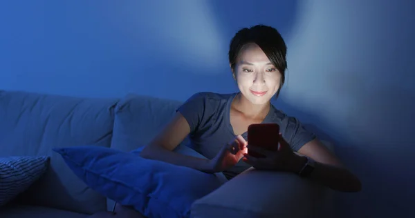 Woman look at cellphone at home in the evening