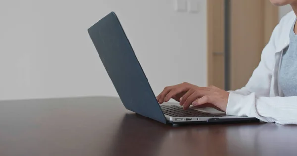 Woman type on laptop computer at home