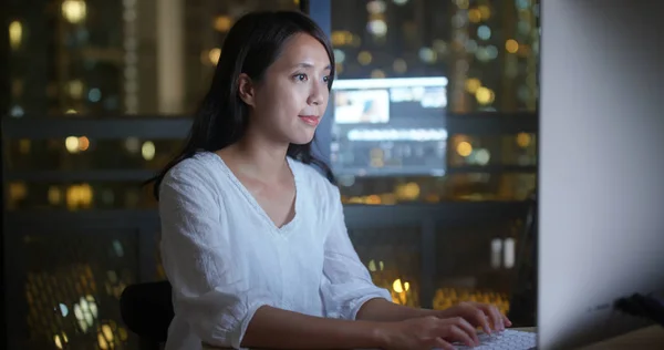 Woman work on computer at night