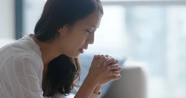 Woman pray to god at home