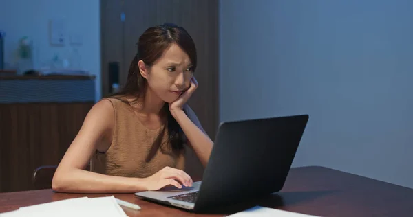 Woman feeling tired on look at the laptop computer at home in th — 스톡 사진