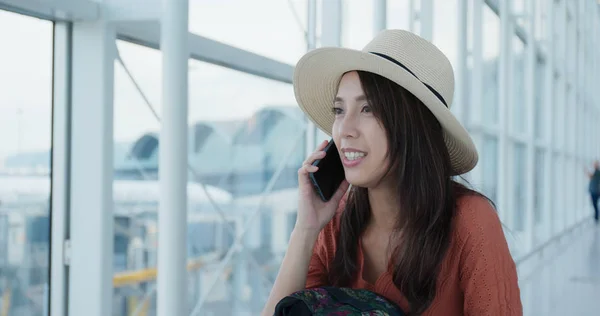 Woman talk to cellphone in the airport