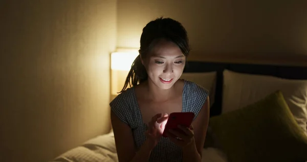 Woman look at mobile phone at night