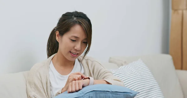 Woman use of smart watch at home — 스톡 사진
