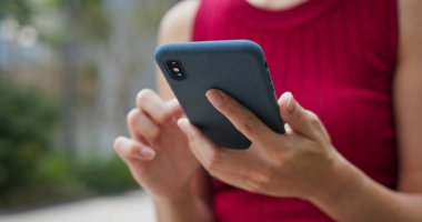 Açık havada akıllı telefon kullanan kadın.