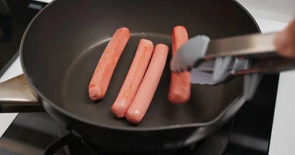 Cooking sausages in the kitchen\ — Photo