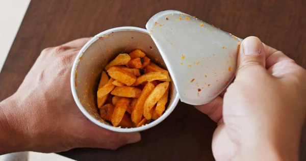 Comer papas fritas de una taza de papel — Foto de Stock
