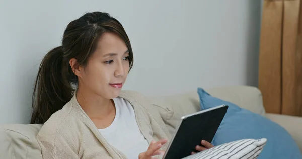 Woman watch on digital tablet computer at home