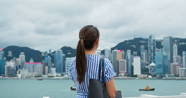 Woman look around the beautiful view in Hong Kong