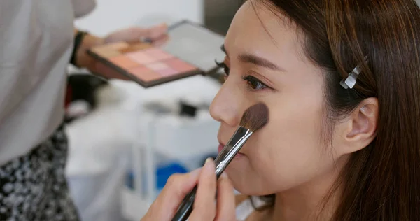 Maquillaje artista hacer maquillaje en la cara de mujer en el salón — Foto de Stock