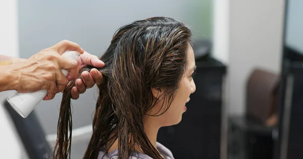 Woman having hair straightening treatment in hair salon — Zdjęcie stockowe