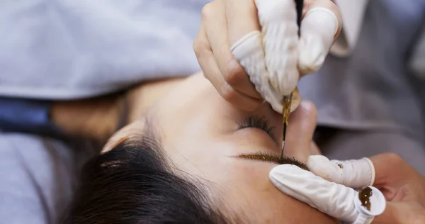 Microblading procedure, master works with the eyebrows