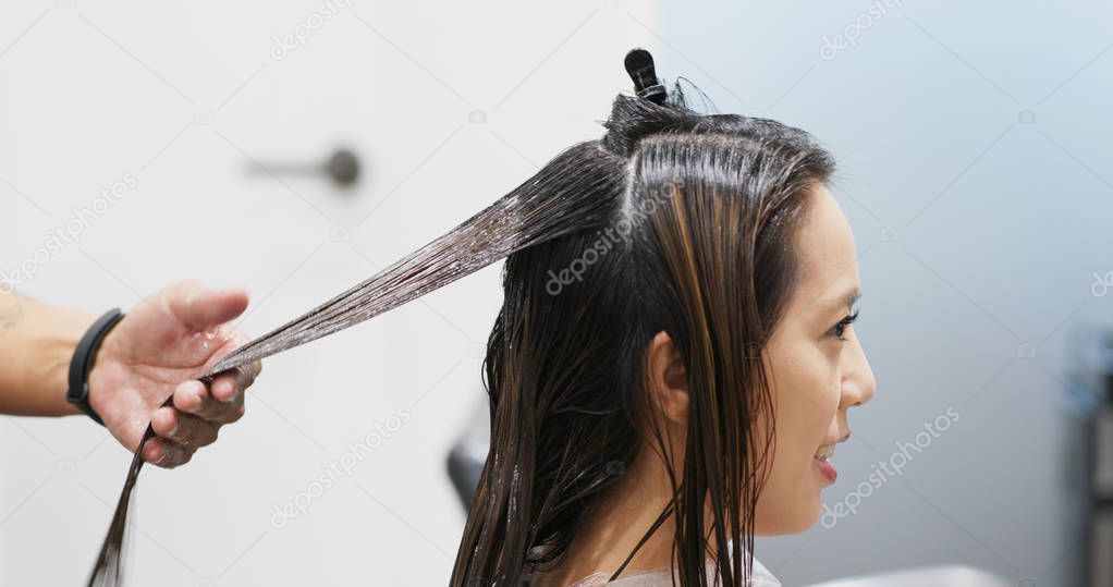 Woman having hair treatment in beauty salon