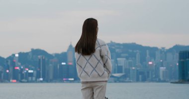 Kadın akşamları şehre bakar.