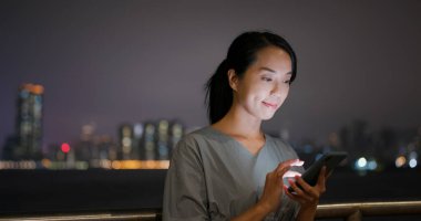 Kadın, gece akıllı telefonu kontrol et.