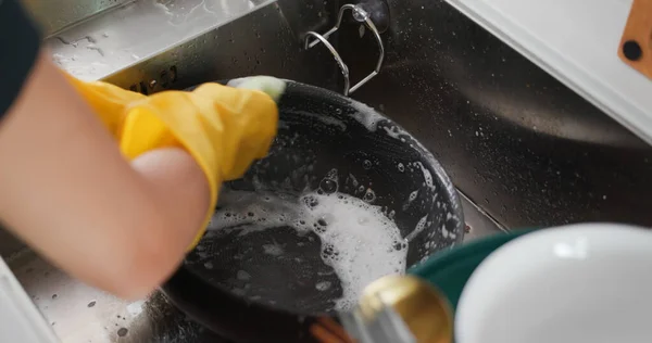 Housewife wash dish in kitchen