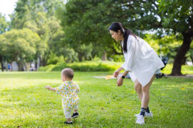 Mother spending time with young boy in park