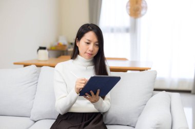 Woman use tablet computer at home