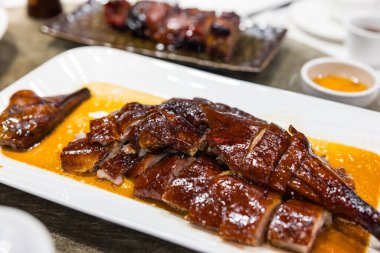 Hong Kong roast goose served with side dish and sauce
