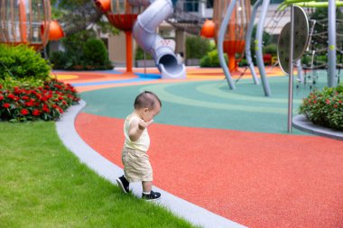 Little baby having fun playing at park