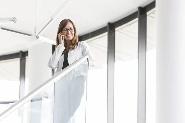 Low Angle View Smiling Businesswoman Talking Smartphone While Standing Office — Stock Photo, Image