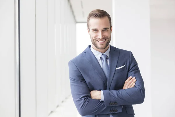 Portrait Smiling Handsome Young Businessman Standing Arms Crossed New Office — Stock Photo, Image