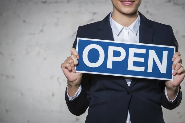 Midsection Young Businesswoman Holding Open Sign Placard Brick Wall — Stock Photo, Image