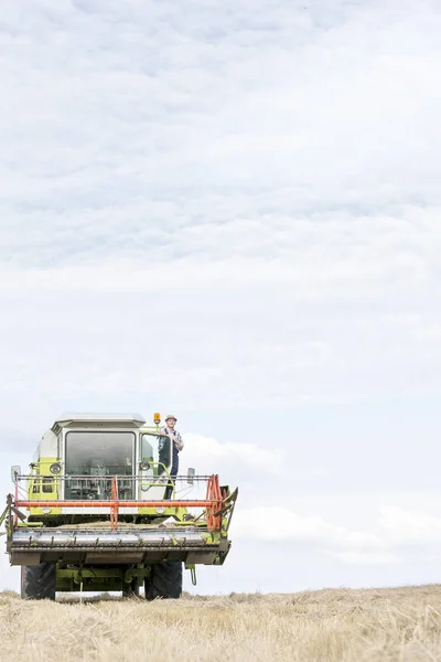 Mature Farmer Standing Harvester Field Sky — Stock Photo, Image