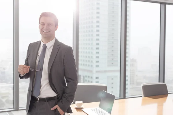 Portrait Smiling Businessman Standing Eyeglasses Boardroom Office — Stock Photo, Image