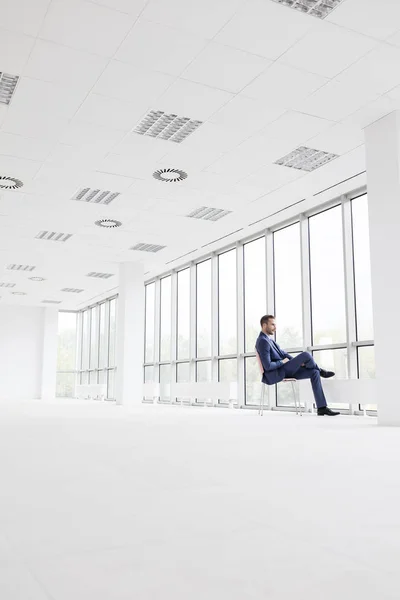 Full Length Side View Businessman Sitting Chair New Empty Office — Stock Photo, Image