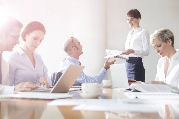 Smiling Businesswoman Giving Documents Businessman Colleagues Meeting Boardroom Modern Office — Stock Photo, Image