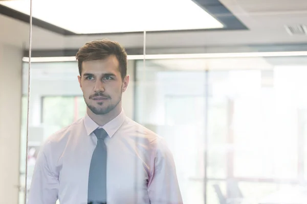 Thoughtful Young Professional Looking Glass Window Office — Stock Photo, Image