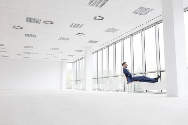 Full Length Thoughtful Young Businessman Relaxing Chair While Looking Window — Stock Photo, Image