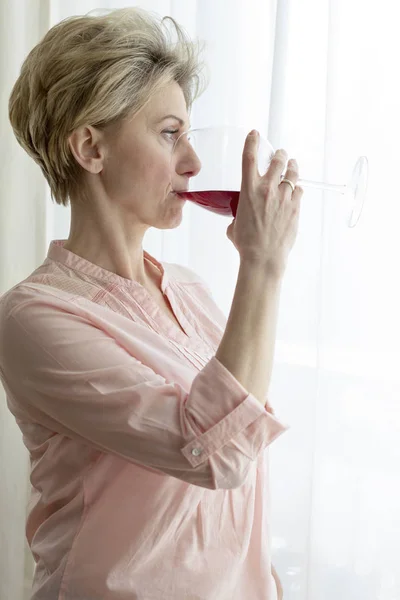 Thoughtful Mature Woman Drinking Wine While Looking Away Home — Stock Photo, Image