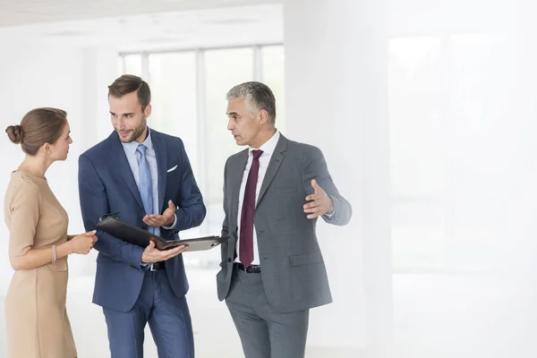 Confident Young Colleagues Discussing Document Mature Businessman New Office — Stock Photo, Image