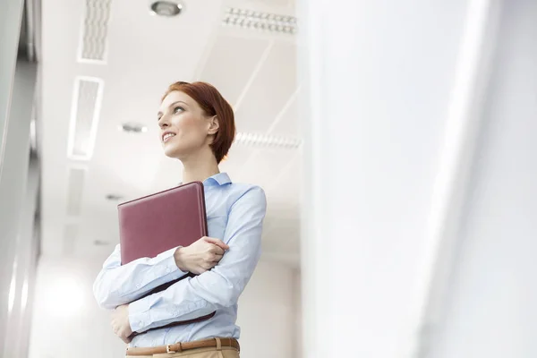 Thoughtful Young Businesswoman Holding Document While Looking Away Office — Stock Photo, Image