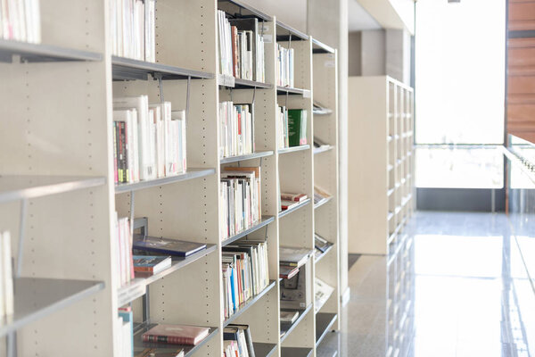 Interior of library with bookshelves in modern university