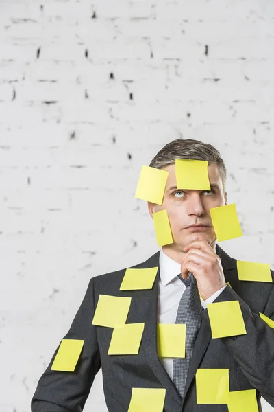 Thoughtful Mature Businessman Blank Yellow Adhesive Notes Face Suit Wall — Stock Photo, Image